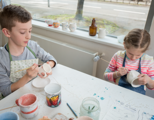 painting donated mugs from Goodwill for flower pots