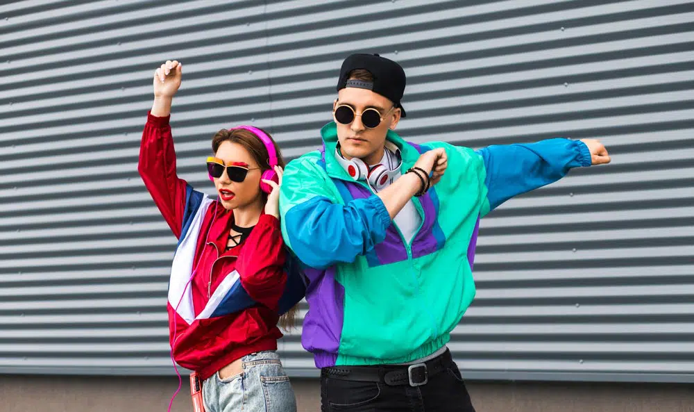 Young people wear bright tracksuits from Goodwill in latest thrifting trends