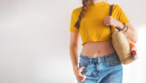 Woman models crop top thrifting fashion trend