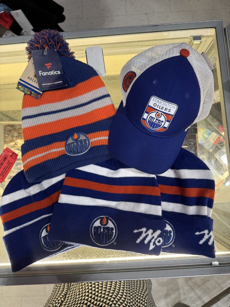 Sustainable & Affordable Thrift Gift Ideas from Goodwill Alberta 12 Oilers toques and hat at Goodwill Alberta store