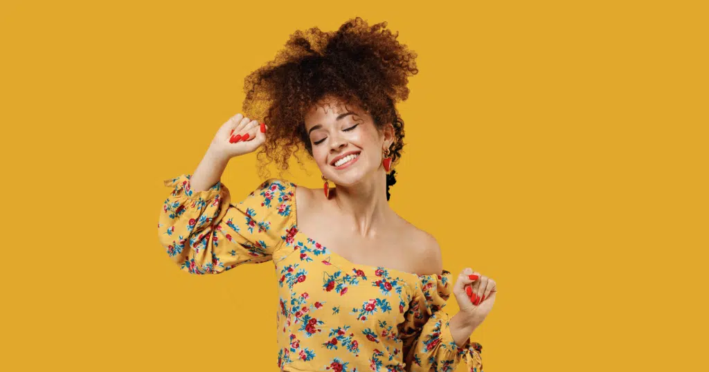 8 TikTok Fashion Trends You Can Thrift 2 Woman wearing colourful floral print top